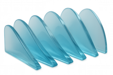 Smooth, translucent blue glass fins form an undulating wave pattern, perfect for design projects needing a touch of modern elegance