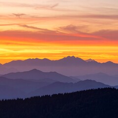 Fototapeta premium Sunset over layered mountain ranges