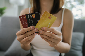 A woman uses her laptop for online banking and payments, managing finances, purchasing goods,...