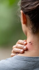 Fototapeta premium Young woman scratches a mosquito bite on her neck, experiencing discomfort and irritation from the insect's attack during an outdoor activity