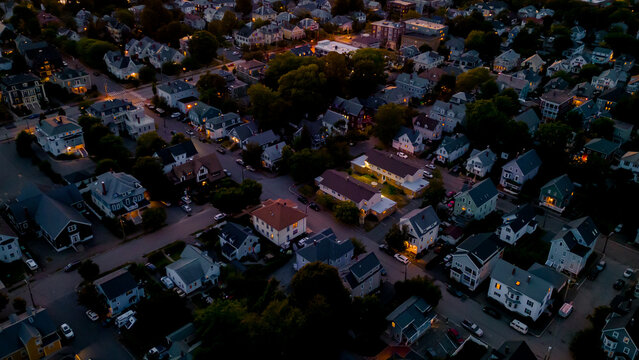 Aerial view of neighborhood at dusk with Victorian homes - Powered by Adobe