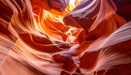 Intricate, warm hues highlight the swirling patterns within a sandstone canyon.