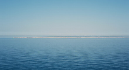 Obraz premium Ocean horizon distant landmass calm water
