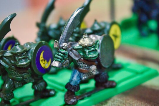 Close-up macro shot of a band of green ogres or orcs, plastic miniatures monsters for a strategy boardgame