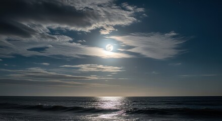 Obraz premium Dramatic Moonlit Ocean Sky with Shimmering Water Surface