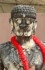 An old giant guardian stucco statue in Wat Phra That Cho Hae