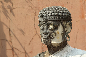 An old giant guardian stucco statue in Wat Phra That Cho Hae