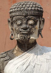 An old giant guardian stucco statue in Wat Phra That Cho Hae