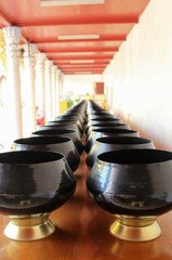 Black monk's alms bowls on the table in Wat Phra That Cho Hae