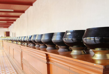 Black monk's alms bowls on the table in Wat Phra That Cho Hae