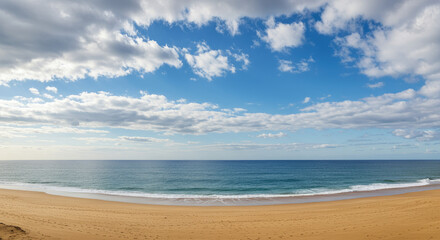 Sandy beach ocean blue sky clouds