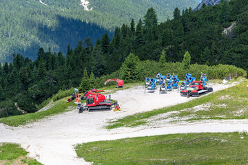 Retractors and snow cannons at the top of  mountains at summer.
