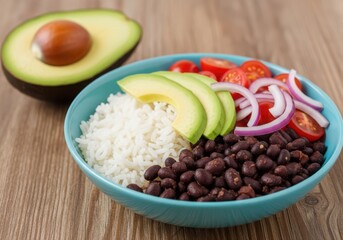 Fresh avocado and black bean rice bowl with tomatoes and onions