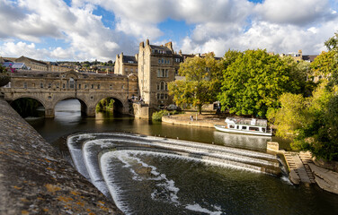 Pulteney bridge over the river Avon with the weir in Bath UK