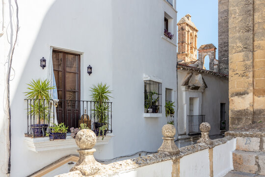 Whitewashed street with balconies Arcos de la Frontera Andalusia Spain 4 September 2025.