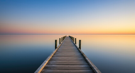Obraz premium Wooden pier extends into calm ocean waters