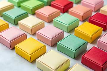 Grid of Small Square Gift Boxes in Various Pastel Colors present packaging Birthday Background