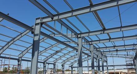 Structural steel frame of a modern building, showing a network of beams and columns.Concept of structural engineering and metal construction.