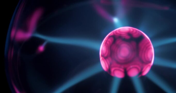 Plasma globe with noble gas inside with filaments extending from inner sphere to outer. Electromagnetic interactions are responsible for glowing filaments. Cinema 4K Slow Motion one minute video