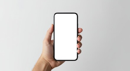 A hand holds a smartphone with a blank white screen against a simple, light gray background.