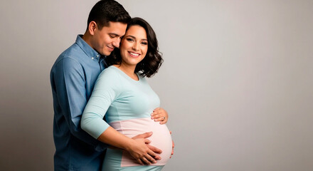 Expecting couple embracing and anticipating the arrival of their baby.
