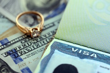 American VISA Marriage or Bride K-1 in United States of America close up. Gold ring with diamond