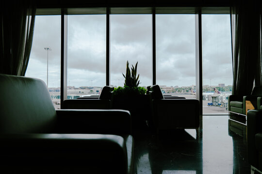 Airport Lounge Interior with Window View of Runway on Cloudy Day
