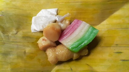 Jajanan pasar or Traditional market snacks consisting of klepon, kue lapis (layered cake), and...