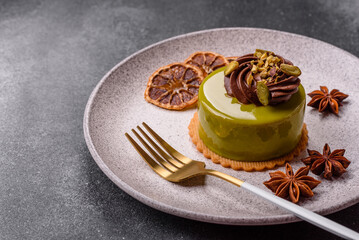 Pistachio cake or tart topped with green mousse with nuts and fruit filling. Pistachio pie