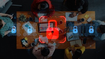 A top-down view of a collaborative team meeting focused on security strategies, featuring digital locks and data visuals in a modern office setting. Raster