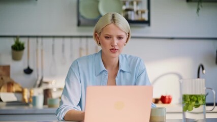 Focused blonde typing laptop at kitchen closeup. Satisfied lady closing computer - Powered by Adobe