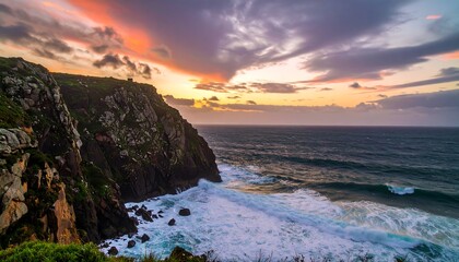 Dramatic sunset over rugged cliffs meeting a churning ocean