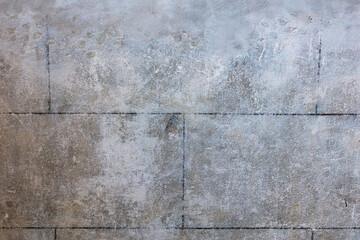 Weathered concrete slab surface with grid seams and patina