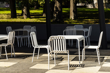 chairs and tables in a summer cafe. furniture for street cafe. outdoor furniture. empty street cafe