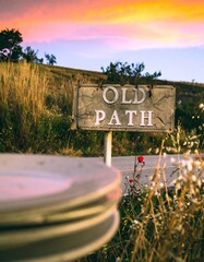 Rustic sign marking "Old Path" at sunset