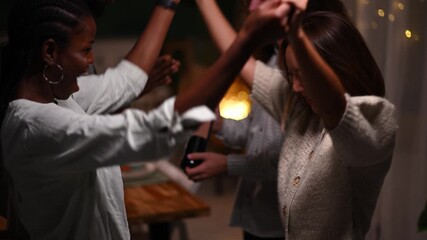 Friends hugging and dancing at thanksgiving dinner party - Powered by Adobe