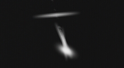 Two blurred glowing objects in the dark night sky suggesting an unidentified aerial phenomenon or...