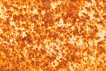 Corroded rusty metal surface texture. Orange brown oxidized steel background with corrosion pattern. Industrial aged metallic detail. Damaged weathered surface closeup. Rough grunge backdrop.