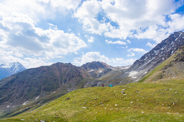 Fototapeta premium There is a man in a camp on the foreground. There are Alatau mountains on the background.