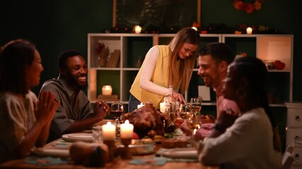 Woman serving thanksgiving turkey to friends at festive dinner table - Powered by Adobe