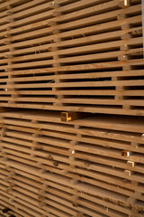 Stack of wooden planks arranged in piles for drying and construction, natural timber material used in carpentry and woodworking industry