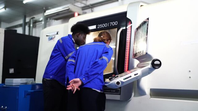 Industrial Collaboration: Two technicians, one male and one female, clad in blue work uniforms.