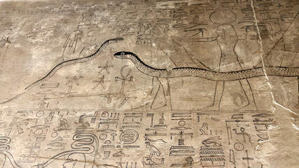 Wall relief of serpents with solar disk and ankh in Valley of the Kings tomb