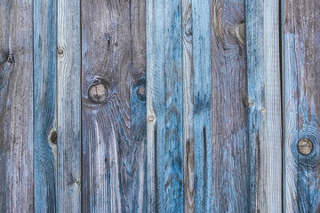 Dark gray seamless texture of an old wooden fence with blue paint, abstract plank background