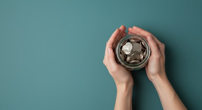 Hands holding a jar of coins, symbolizing savings and financial growth