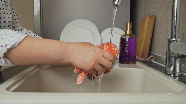Female hands preparing the trout fish for cooking at home kitchen. Concepts of healthy eating and seafood