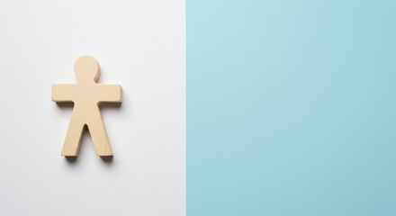 Obraz premium A single wooden figure stands on a split white and blue background, symbolizing individuality and distinction