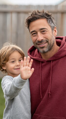 Fototapeta premium Father’s day celebration with smiling father in red hoodie and child in outdoor setting