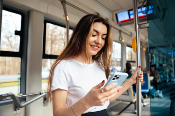 Young woman enjoying smartphone while traveling on public transport, smiling and relaxed, modern urban setting, technology lifestyle concept