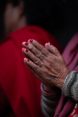 Close-up of elderly woman's hands in prayer. A symbolic gesture of faith, devotion, spirituality in Asian culture. Perfect for illustrating concepts of religion, meditation, worship and inner peace.